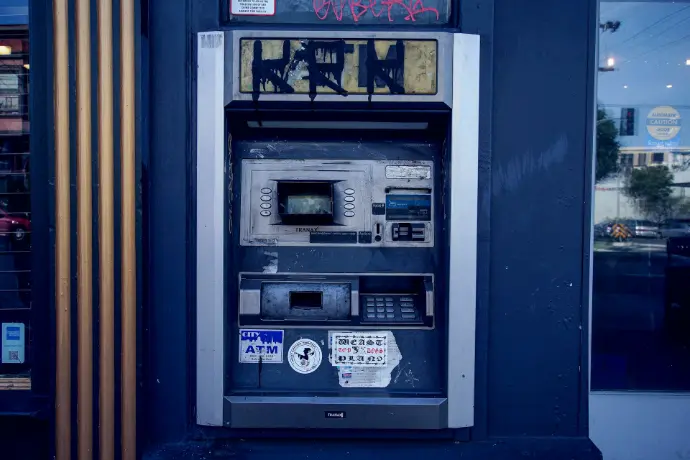 an old fashioned payphone with graffiti on the side of it